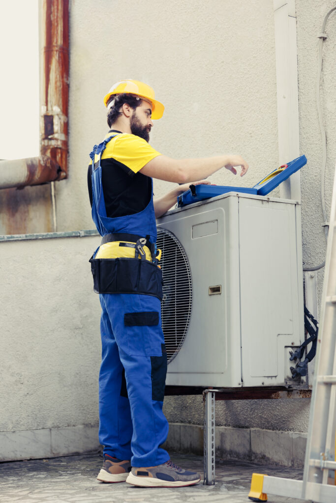 repairman reconditioning hvac system