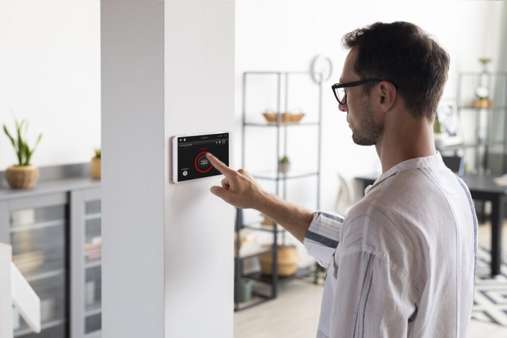 Is an AC Service Agreement Worth It? Here's the Real Math 2 man using tablet his smart home