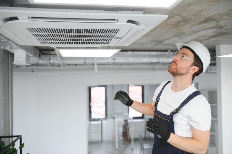 Indoor Air Quality in South Florida: What Palm Beach County Homeowners Need to Know 10 imgi 46 young repairman repairing ceiling air conditioning unit 255667 46052